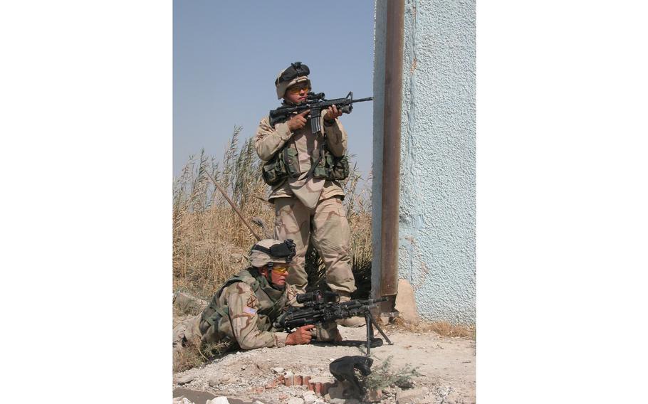 The glamour of infantry work: Soldiers from the 10th Mountain Division’s Company C, 4th Battalion, 31st Infantry Regiment work around rotten trash as they secure the perimeter of Saba al Boor police station in Iraq.