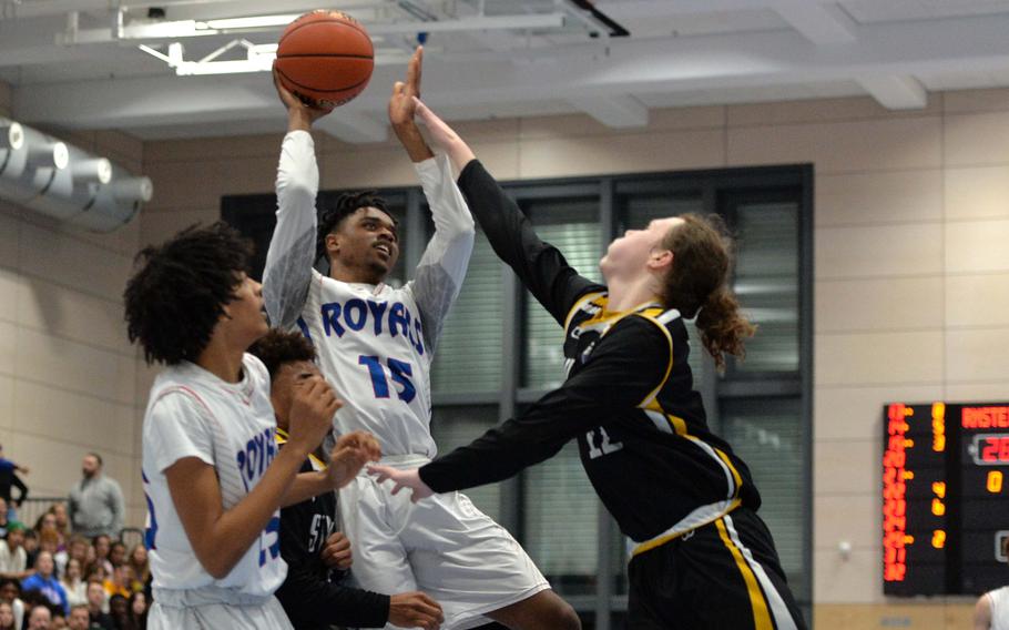 Ramstein’s Jayvian Jennings gets a shot off over Stuttgart’s Christopher Hess in the Division I championship game at the DODEA-Europe basketball championships in Ramstein, Germany, Feb. 18, 2023. Stuttgart took title with a 62-60 double overtime win.