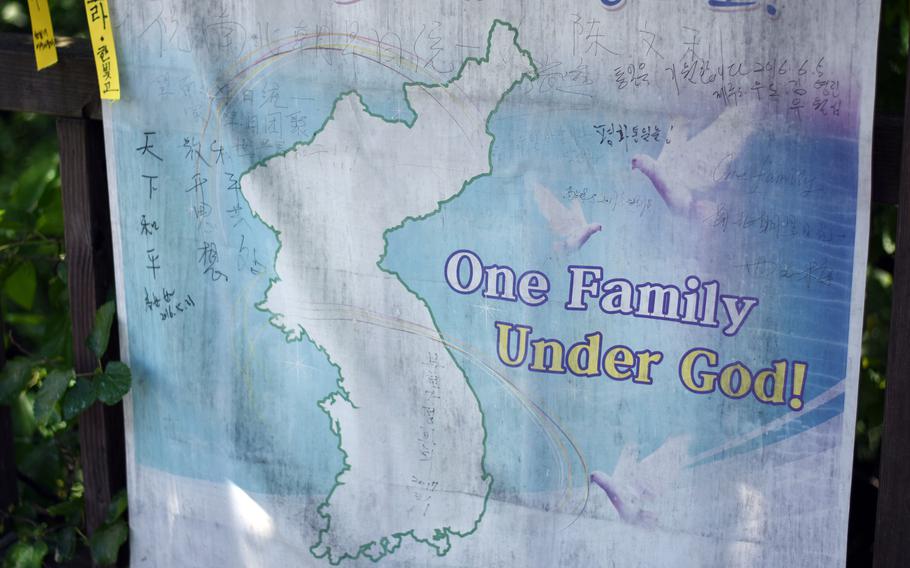 A reunification banner hangs on a fence near the Demilitarized Zone in Paju, South Korea, May 24, 2017.