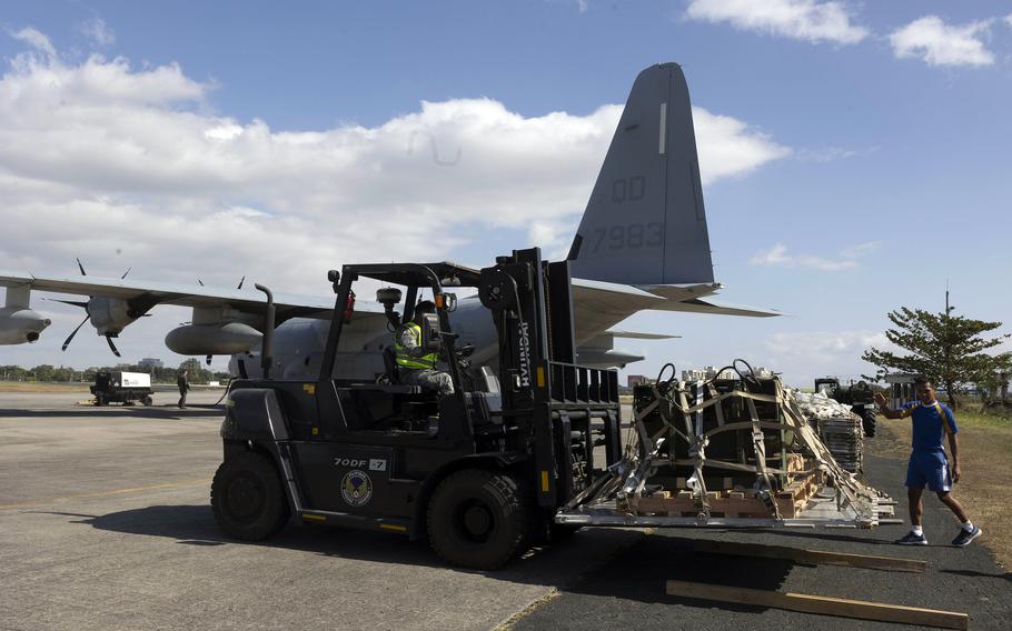 Philippine airmen unload equipment from a U.S. Marine Corps KC-130J Super Hercules at Villamor Air Base in Pasay, Philippines, Feb. 11, 2024.