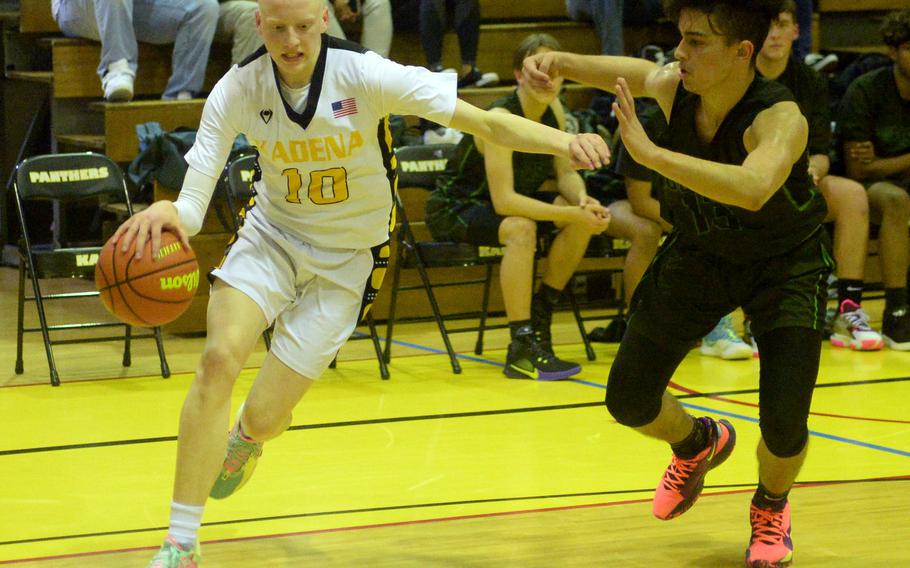 Kadena's Andrew Eaglin dribbles against Kubasaki's Erick Camacho during Friday's Okinawa boys basketball game. The Panthers won 43-35.