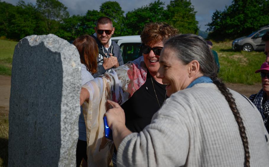 Jamie Jamison, center, talks to a French journalist about her grand uncle Bernard Gautier at the site where he landed with his small special forces paratrooper element in 1944 near Berlats, France. Gautier died six days after his arrival to France during a firefight with German troops.