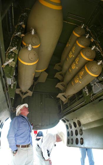 A man checks out a bomb bay in an aircraft
