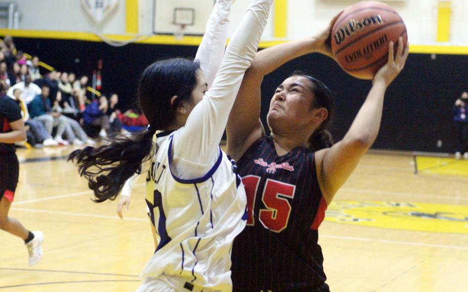 Nile C. Kinnick's Leona Turner tries to shoot against Academy's Mia Marchessault.