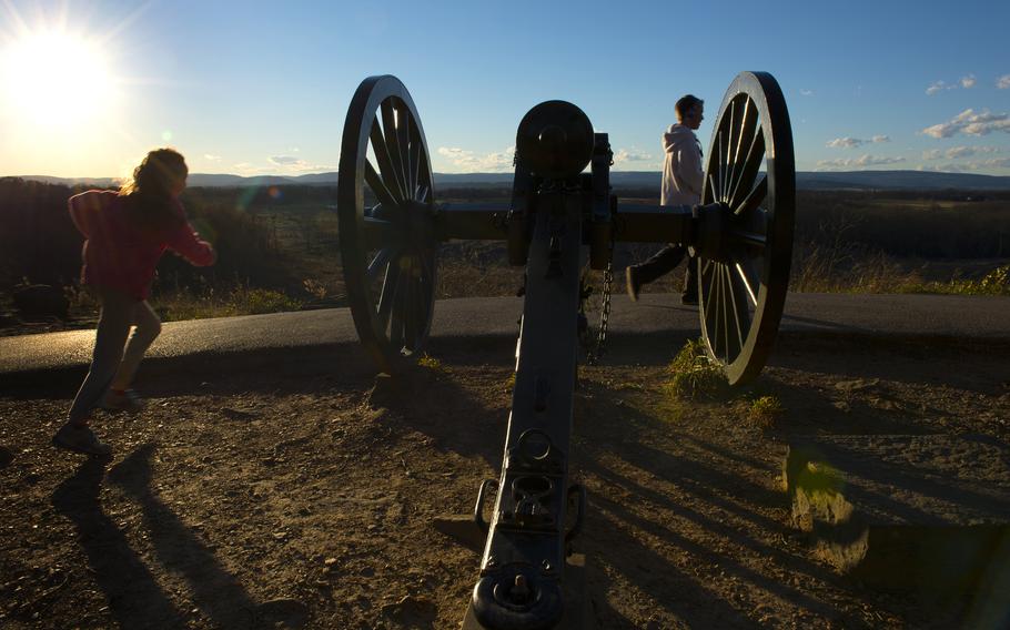 Two children play near a cannon on Little Round Top Hill in 2013.