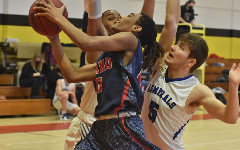 Aviano's Deon Walker attempts a shot as Rota's Noah White, right, and Emory Butler defend Thursday, March 3, 2022 at the first day of the DODEA-Europe Division II basketball championships.