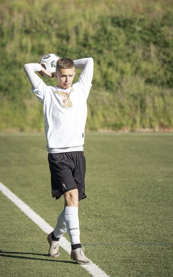 Russel Checketts, a senior with the Spangdahlem Sentinels, throws the ball into play during a match against the Alconbury Dragons at the 2025 DODEA European Division III soccer championships in Landstuhl, Germany on May 19, 2025.