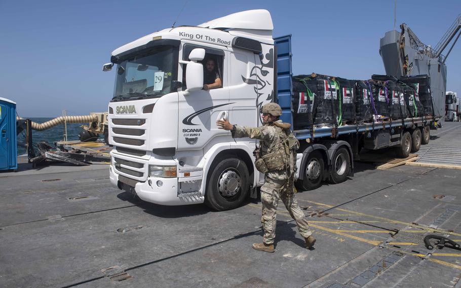 A driver transports humanitarian aid from a U.S. Army vessel across the floating pier and onto the beach in Gaza on June 8, 2024. 