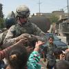 U.S. soldiers score big with the Iraqi children of the Isla Zeral neighborhood of Mosul in 2005, as the kids call out for candy or soccer balls.
