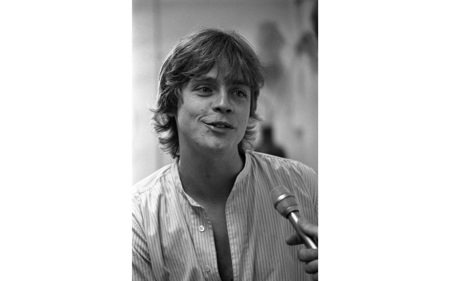 Mark Hamill chats into a reporter's microphone during an interview at Nile C. Kinnick High School. 