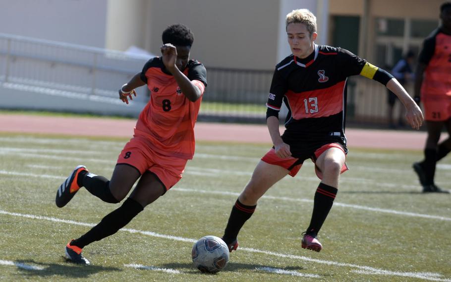 Nile C. Kinnick's Leon Awesso plays the ball against E.J. King's Kai Sperl during Saturday's DODEA-Japan boys soccer match. The Red Devils won 6-0.