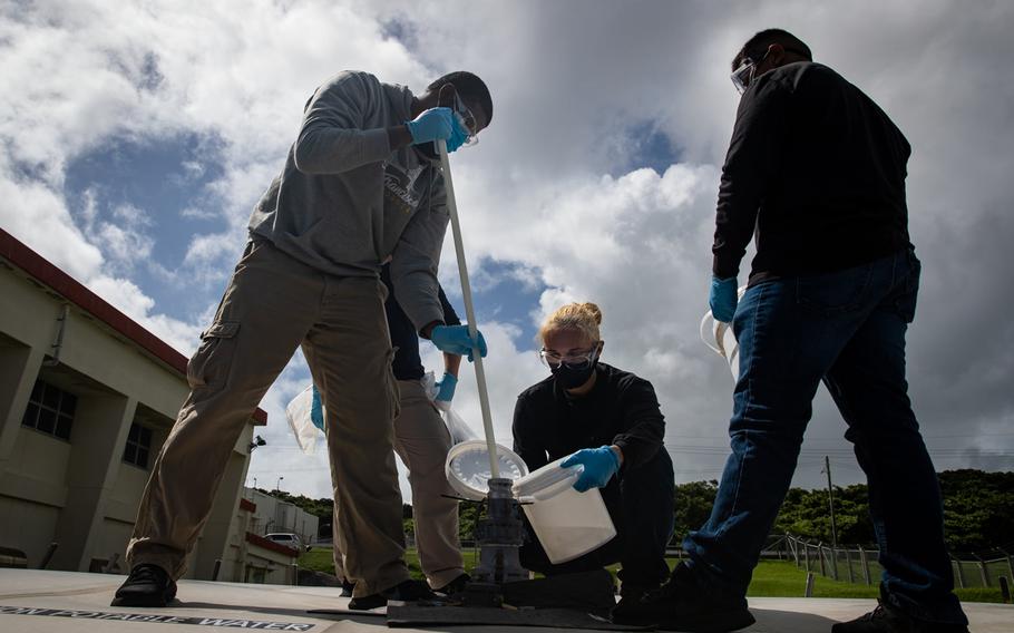 Japanese officials collected samples of treated wastewater at Marine Corps Air Station Futenma, Okinawa, Monday, July 19, 2021.