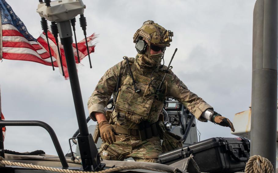 A service members prepare to board an inflatable boat.