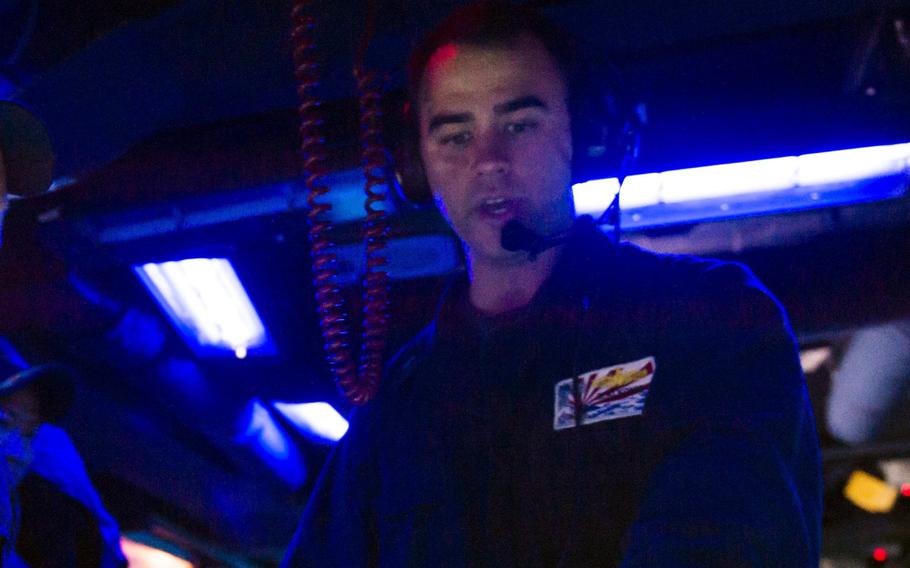 Ridge Hannemann Alkonis, then a junior-grade lieutenant, works aboard the guided-missile destroyer USS Fitzgerald in the Timor Sea, July 9, 2015. 