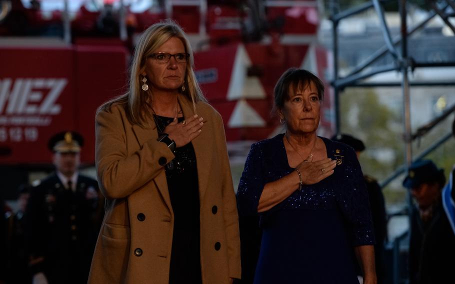 Sarah Taylor, left, first vice president of American Gold Star Mothers, and Jo Ann Maitland, the national president of the organization, pay their respects before the eternal flame at the Arc de Triomphe, in Paris, Oct. 26, 2021. The Gold Star designates parents whose child died in combat.