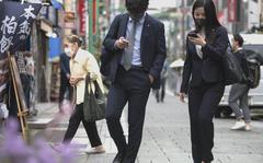 Most urban dwellers in Japan, including these pedestrians in Yokohama on May 12, 2021, wear masks as protection against the coronavirus. 
