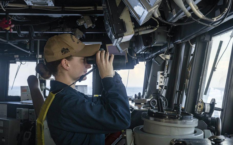 Ensign Julia Olson stands watch from the bridge of the guided-missile destroyer USS Rafael Peralta near the Luzon Strait, March 1, 2024. 