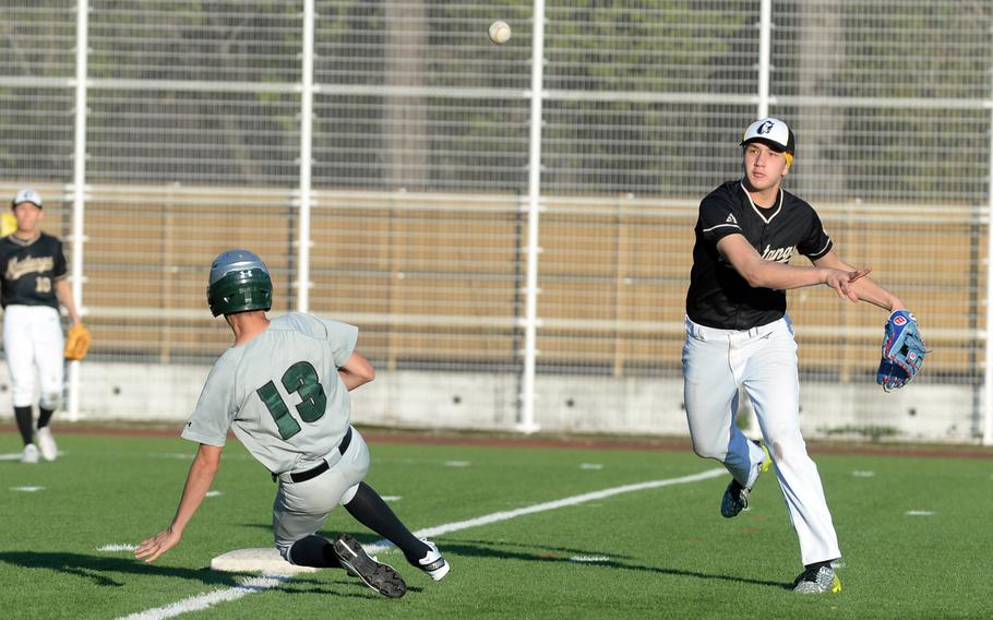 American School In Japan's Shou Murakami-Moses sends a relay throw to first base after erasing Kubasaki's Drake Garza at second. The Mustangs won 13-4 in Friday's second game.