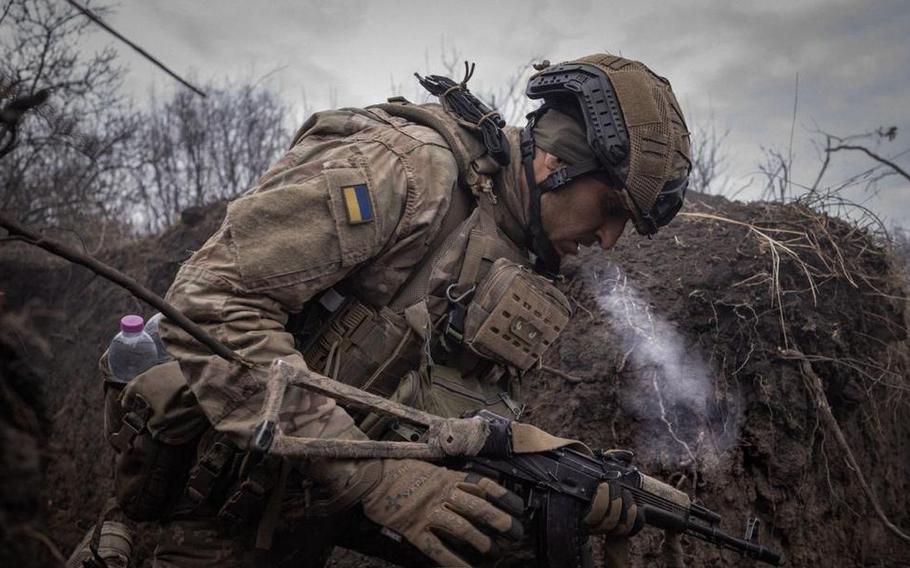 A Ukrainian soldier assigned to the 93rd Mechanized Brigade checks his weapon in an undated photo shared by Ukraine's Defense Ministry on Nov. 27, 2023. During meetings Nov. 29 in Brussels, Ukrainian Foreign Minster Dmytro Kuleba highlighted his country's importance to Europe's defense, due to the military's combat experience. 