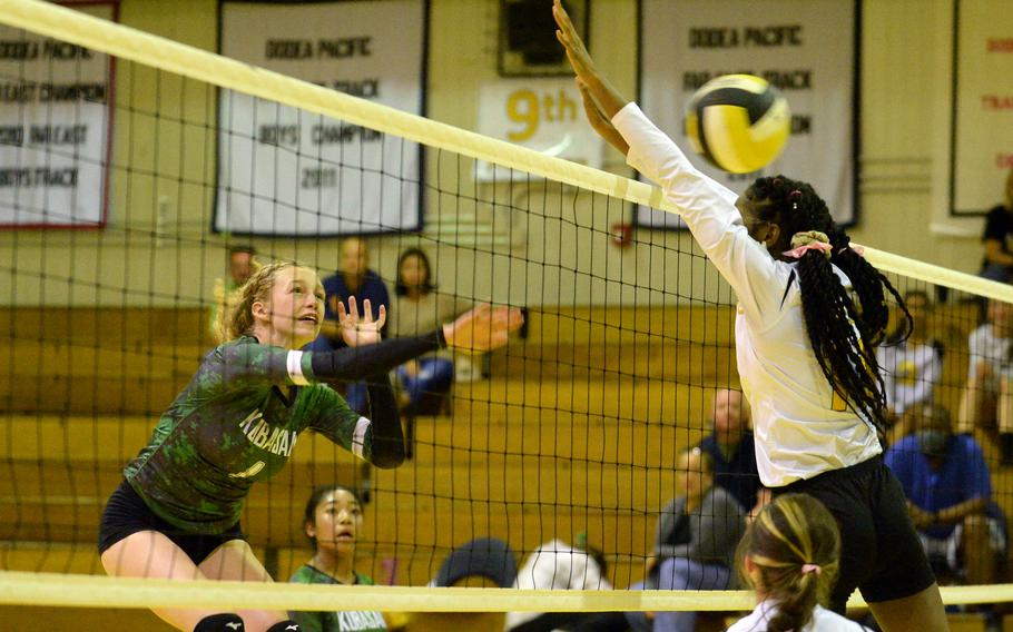 Kubasaki's Emma Leggio spikes against Kadena's Liza Young during Tuesday's DODEA-Okinawa volleyball match. The Dragons won in four sets.