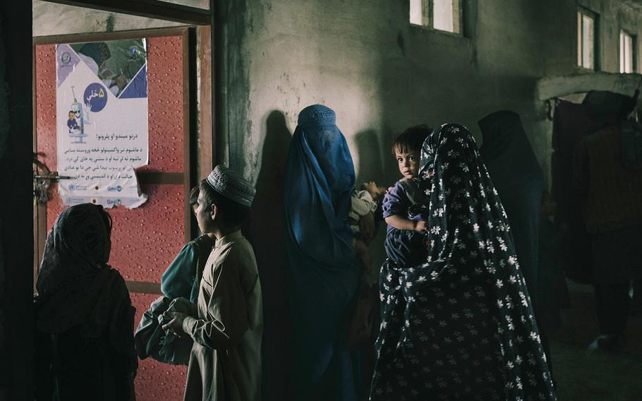 Women complain of long wait times at the main clinic in Sangin, on June 15, 2022.