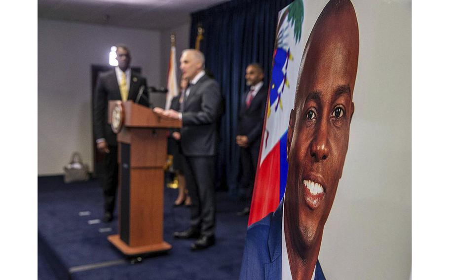 Assistant Attorney General Matthew G. Olsen, on podium, of the Justice Department’s National Security Division joined the U.S. Attorney Markenzy Lapointe, far left, in Miami on Feb. 14, 2023, as they announce developments in the U.S. government’s prosecution of individuals allegedly connected to the assassination of Haitian President Jovenel Moise. 