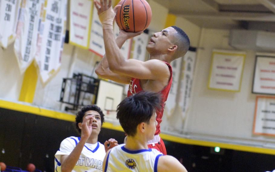 Kinnick's Vance Lewis drives into St. Mary's Julian Willis while trying to shoot. A blocking foul was called on Willis.