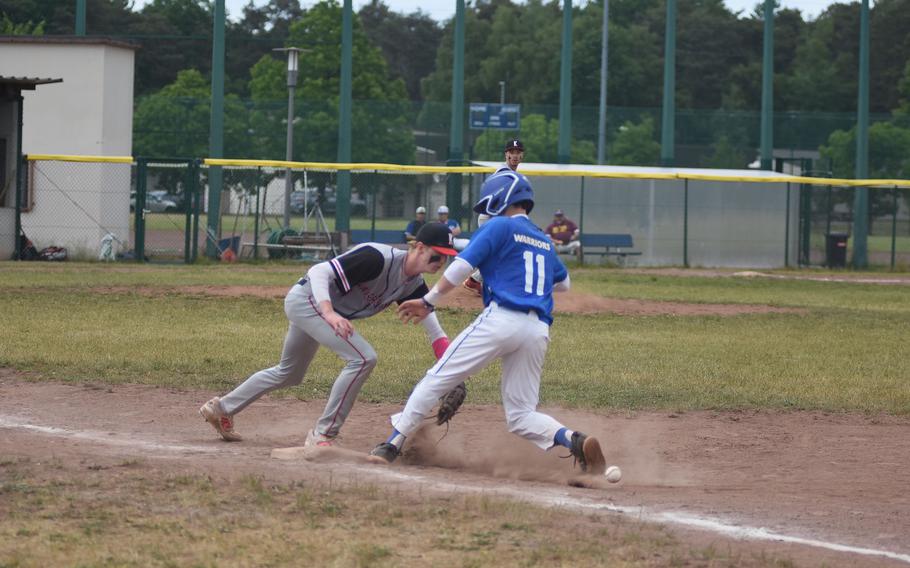 The ball gets away Thursday, May 22, 2025, as Wiesbaden's Jonah Harvey gets back into first on a pickoff attempt while Kaiserslautern's Bryant Lokey tries to make the tag.