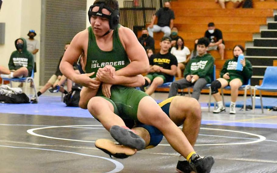 Danen Mendiola of Guam High trips John F. Kennedy's Keenan Taijeron at 160 pounds during Saturday's Guam wrestling dual meet. Mendiola pinned Taijeron in 1 minute, 53 seconds and the Panthers won the meet 48-21.