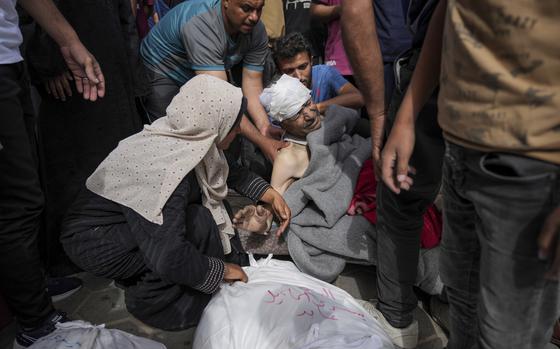 Palestinians mourn relatives killed in the Israeli bombardments of the Gaza Strip in front of the morgue of the Al Aqsa Hospital in Deir al Balah, Gaza Strip, on Saturday, May 11, 2024. (AP Photo/Abdel Kareem Hana)