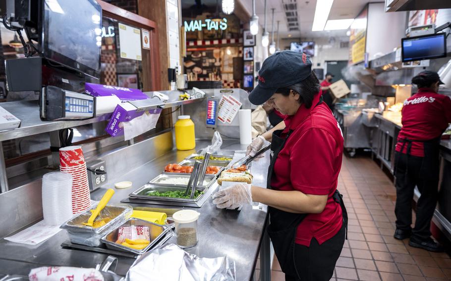 An employee prepares food at a Portillo’s restaurant in Chicago.