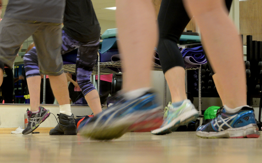 Dancers move their legs during a Zumba class.