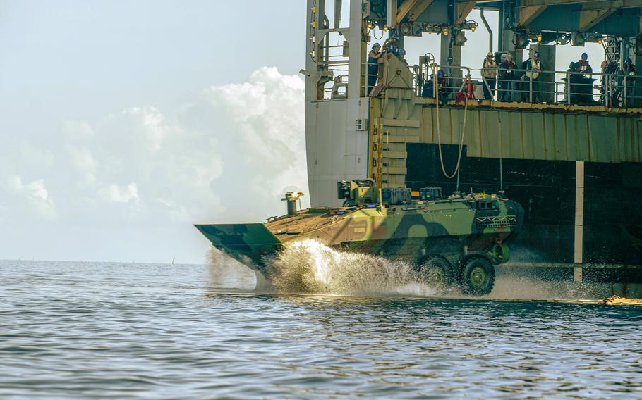 An amphibious combat vehicle attached to the 15th Marine Expeditionary Unit splashes off the amphibious dock landing ship USS Harpers Ferry during a Balikatan drill in Oyster Bay, Philippines, May 4, 2024.