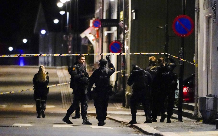 Police stand at the scene after an attack in Kongsberg, Norway, Wednesday, Oct. 13, 2021. Several people have been killed and others injured by a man armed with a bow and arrow in a town west of the Norwegian capital, Oslo. 