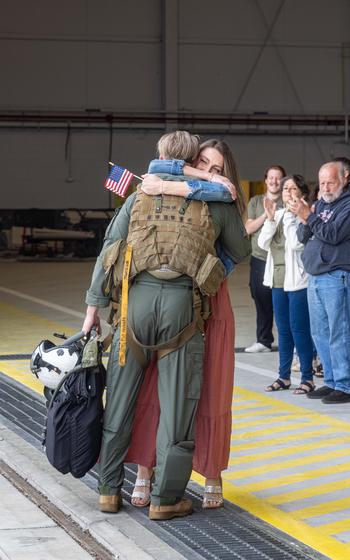 A U.S. Marine MV-22B Osprey pilot is reunited with a loved one after returning from deployment with the 26th Marine Expeditionary Unit, Marine Corps Air Station New River, N.C., Saturday, March 16, 2024.