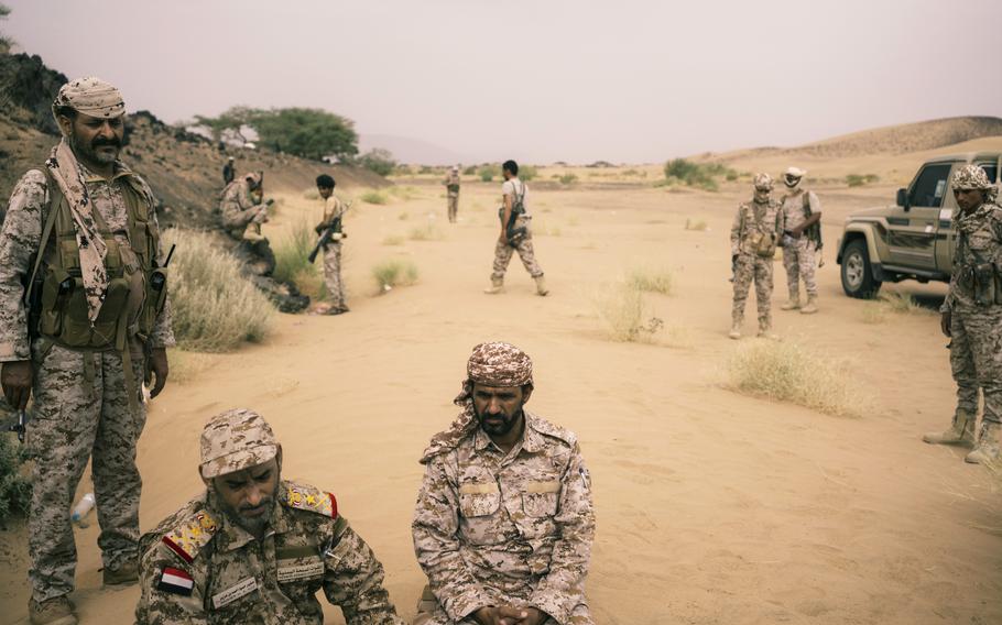 Lt. Gen. Sagheer bin Aziz, bottom left, sits near a front-line position outside Marib on Aug. 15. 