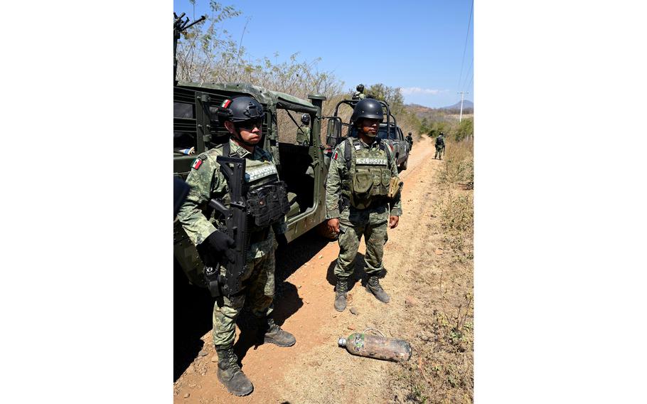 Soldiers of the special forces of the Mexican Army show an explosive device used as an antipersonnel mine by the Jalisco Nueva Generacion Cartel (CJNG) in the community of Naranjo de Chila, municipality of Aguililla, Michoacan state, Mexico, on Feb. 18, 2022.