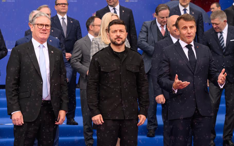 British Prime Minister stands next to the Ukrainian Presidentand French Prime Minister.
