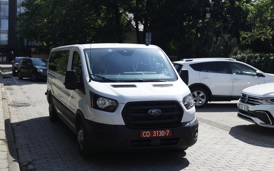 A white van parked on a street.