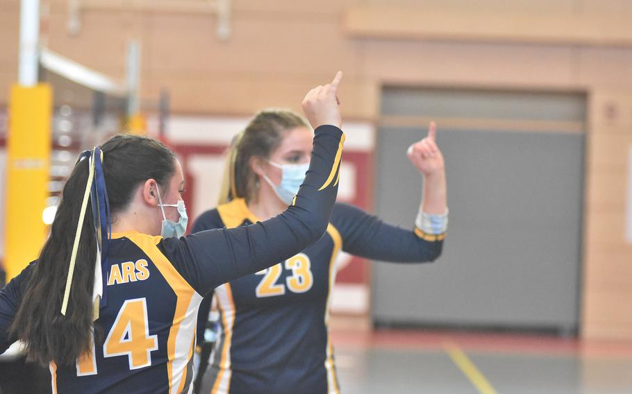 Ansbach's Georgia Bryant, left, and Melanie Wetherell-Smith signal they're a point away from taking a set during round-robin play at the DODEA-Europe Division III tournament Friday, Oct. 29, 2021, in Kaiserslautern, Germany.
