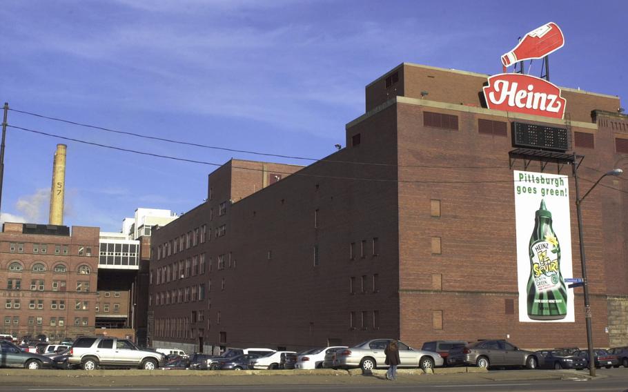 A large red-brown building with the Heinz logo on its street-facing side.