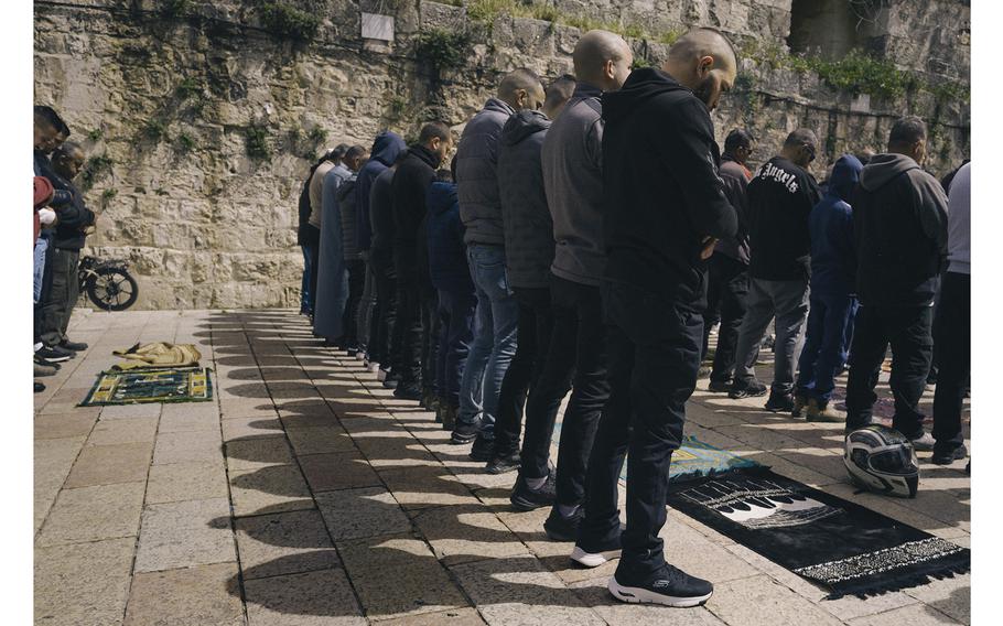 Men pray in a square outside al-Aqsa Mosque on March 15, 2024. The first Friday of Ramadan passed peacefully.