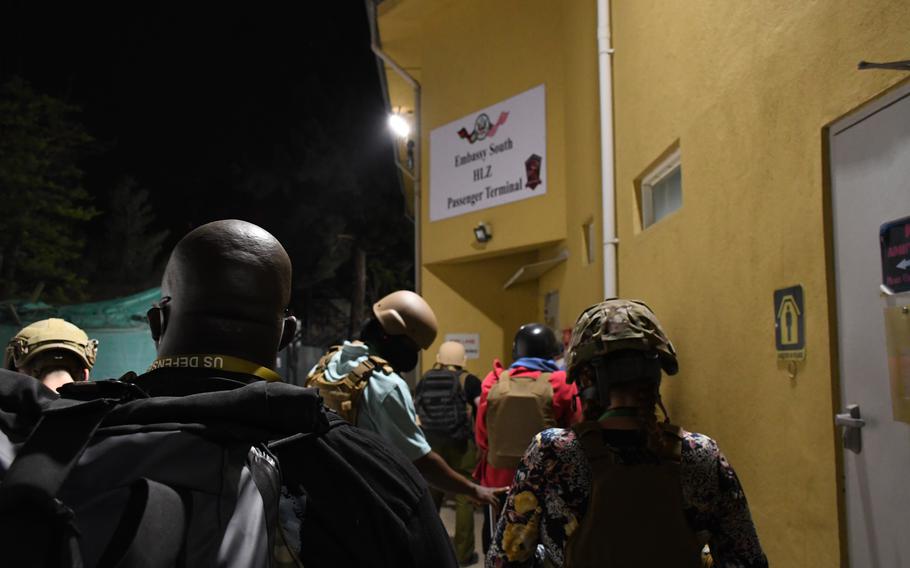 Employees at the U.S. Embassy in Kabul, Afghanistan, prepare to board a helicopter just after midnight on Sunday, Aug. 15, 2021. They would await flights out of the city's airport while reports came in of the Taliban advancing on the capital.