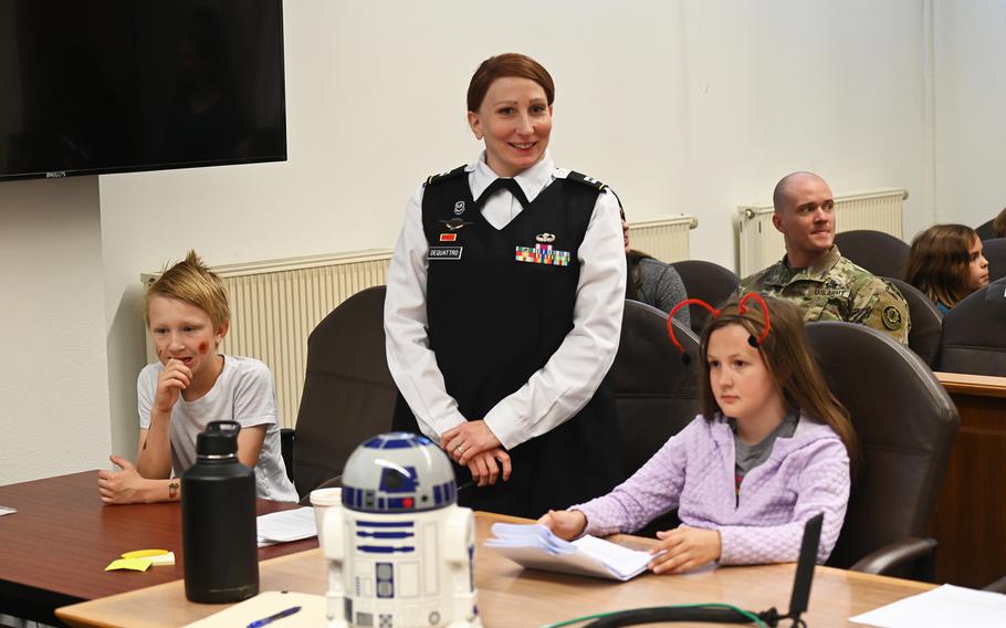 Luke Skywalker, left, portrayed by Grafenwoehr Elementary School fourth grader Landon Wright, sits at the defense table for his mock trial, alongside adviser Capt. Dee Dequattro and co-counsel Maddi Money, in the 8th Judicial Circuit courtroom at Rose Barracks in Vilseck, Germany, on May 20, 2024.