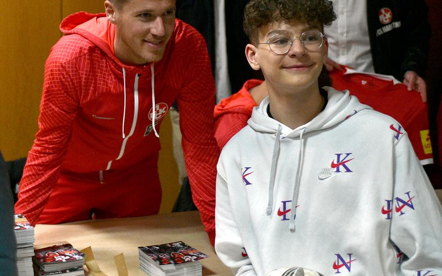 Joshua Weissert, right, poses for a photo with 1. FC Kaiserslautern defender Erik Durm on March 23, 2023, at the community center on Ramstein Air Base, Germany. Drum and the Red Devils took their first-ever tour of the base.