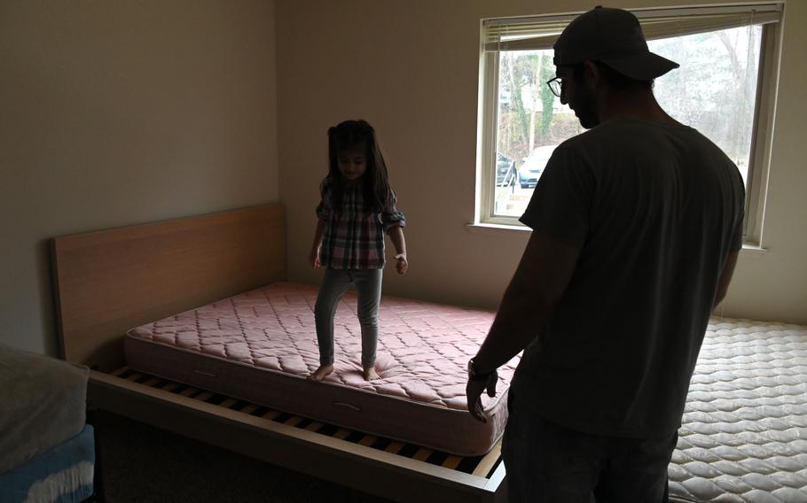 Atal Zadran watches his niece, Hareer, as she checks out the beds in Atal’s new apartment. The Afghan family moved into a Howard County apartment after fleeing their country and the Taliban.