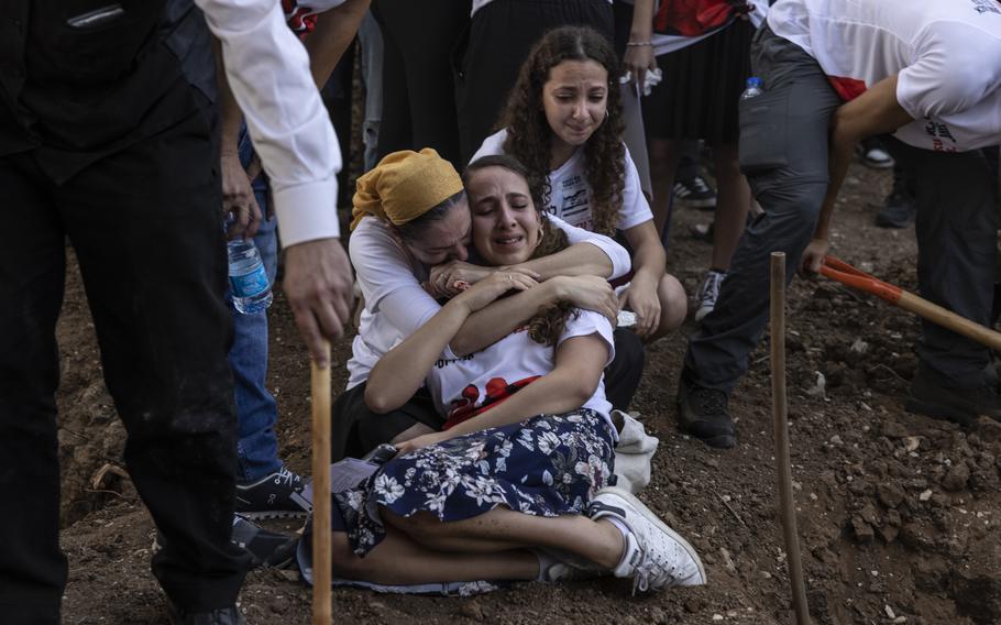 Relatives and friends grieve during a funeral in Kfar Harif, Israel, on Oct. 25, 2023.