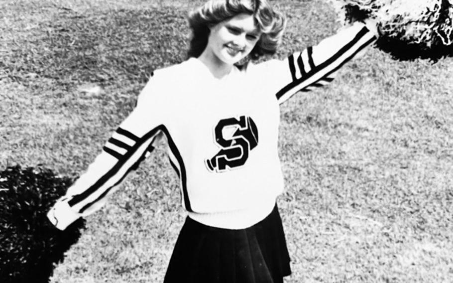 Debbie Mills cheers on the Kubasaki High School football team at Camp Foster, Okinawa, in the early 1980s. 