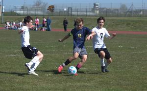 Daymien Abitua, co-captain of Ansbach's boys soccer team, shoots what will be the first of his three goals against Hohenfels' co-ed team in a 6-0 Ansbach win on April 12, 2025, in Ansbach, Germany.