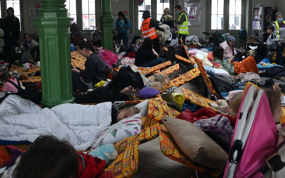 Women and children from Ukraine rest in a hall at the Przemysl, Poland, train station, March 2, 2022.